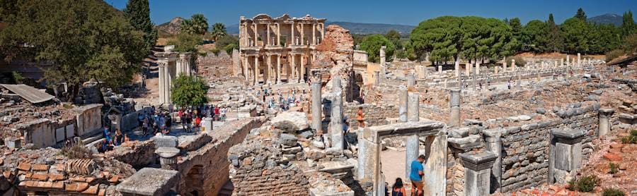 Wide view over the ruins of central Ephesus with the two-story facade of the Library of Celsus beyond