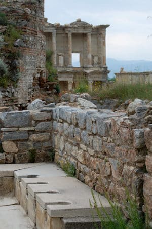 The public latrines of Ephesus with the Library of Celsus behind