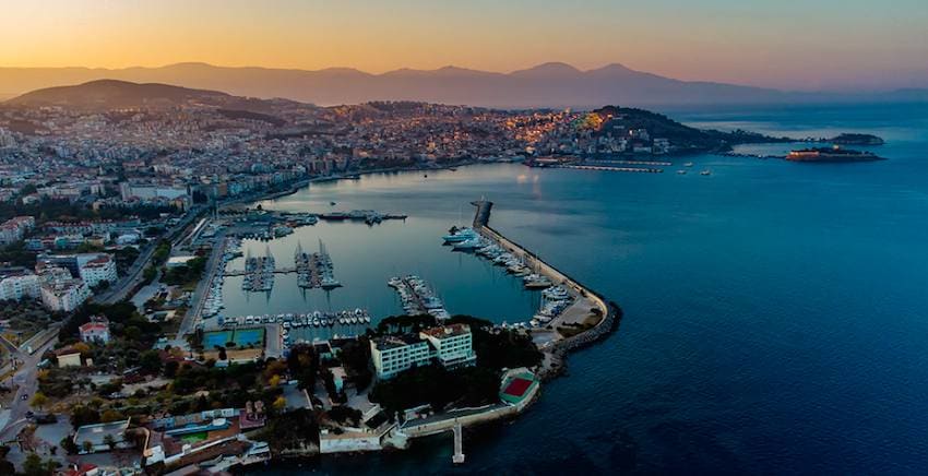 Aerial view of Kusadasi at sunset with its marina, breakwater and the causeway out to Pigeon Island