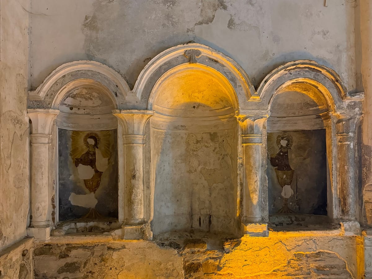 Two painted niches beside the apse of the Church of St John the Baptist in Sirince, each showing Christ rising from a golden chalice