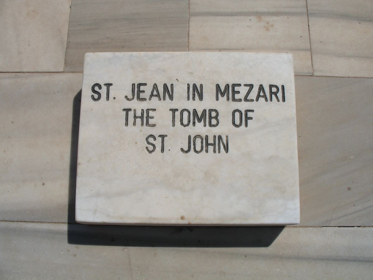 White marble marker stone engraved St. Jean in Mezari, The Tomb of St. John, set on the marble floor of the tomb platform
